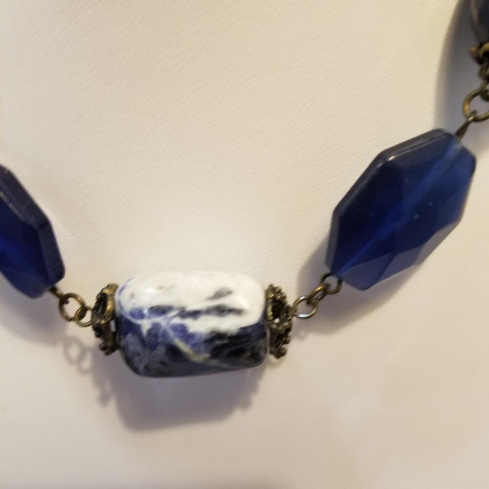 Blue and white faceted stones w/ intricate bead caps 14" with a three inch ext.